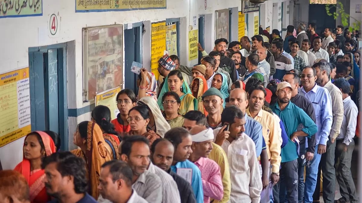 Voters wait in a queue at a polling station to cast their votes in Jabalpur, Madhya Pradesh.