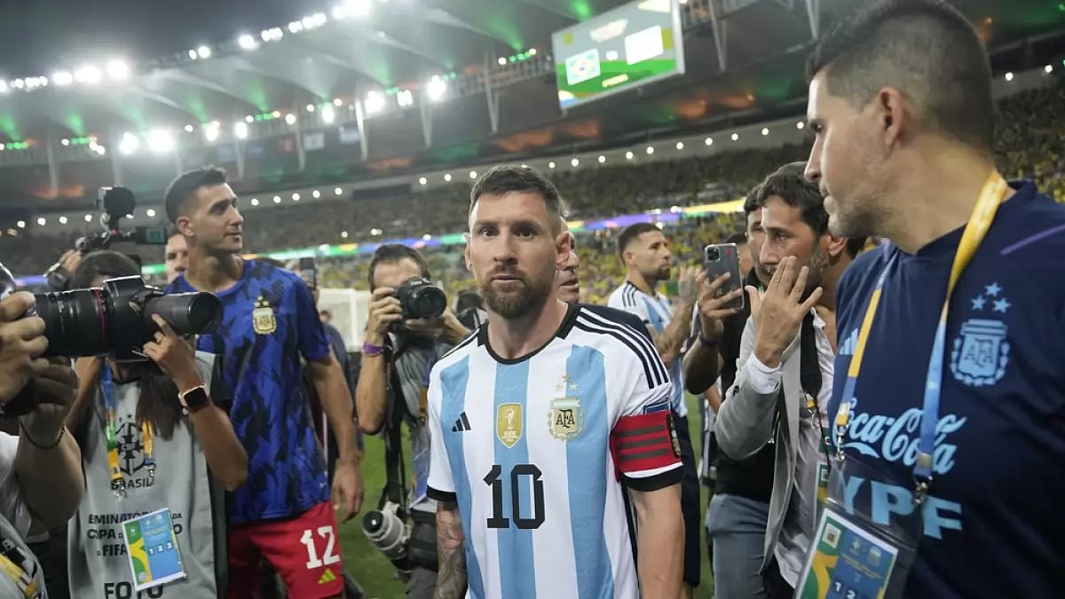 Lionel Messi (c) leaves the field after a fight between Brazilian and Argentinian fans broke out in 