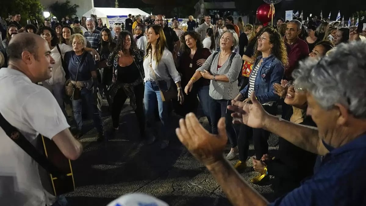 People react as they hear the news of the release of 13 Israeli hostages held by Hamas in Gaza