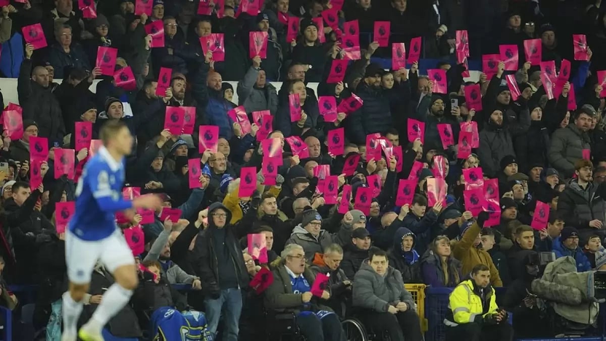 Everton fans showing cards with 'corrupt' written during the English Premier League football match