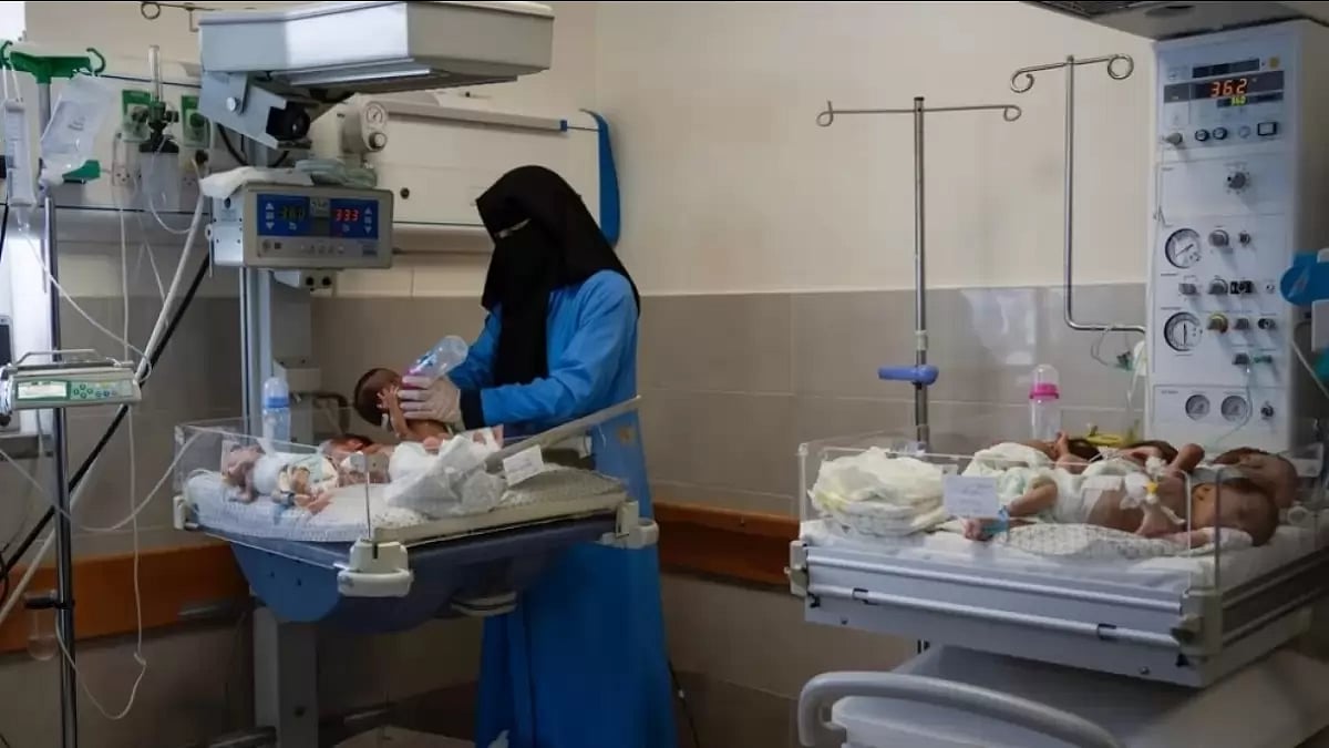 A nurse prepares babies for transport to Egypt after they were evacuated from Shifa Hospital 