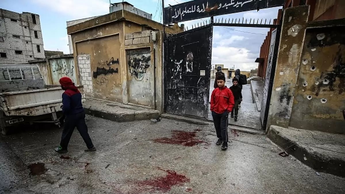 Syrians are seen after Assad Regime's airstrike held with cluster munition hit a school 