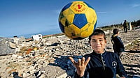 Resistance Of Lullaby: Gaza Comes More Fearlessly Through The Faces Of Children A Palestinian boy plays amidst the rubble of the destroyed Al-Aqsa university