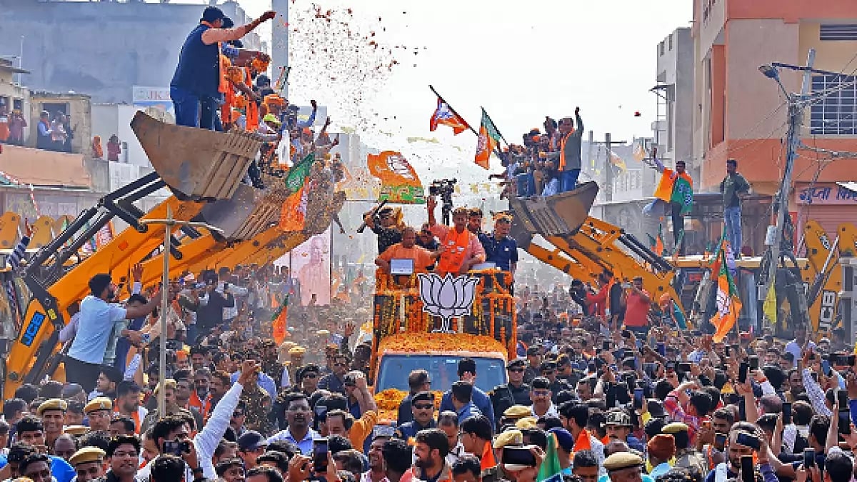 Yogi Adityanath is participating in a roadshow aboard a bulldozer in support of BJP candidate 