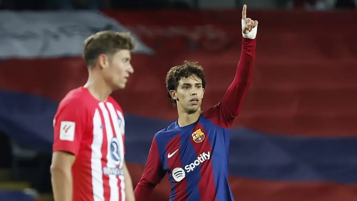 Barcelona's Joao Felix (R) celebrates his goal against Atletico Madrid during the La Liga 2023-24