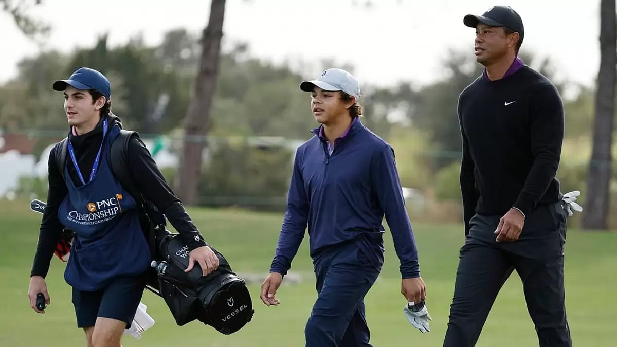Tiger Woods (right) with his son Charlie (c)