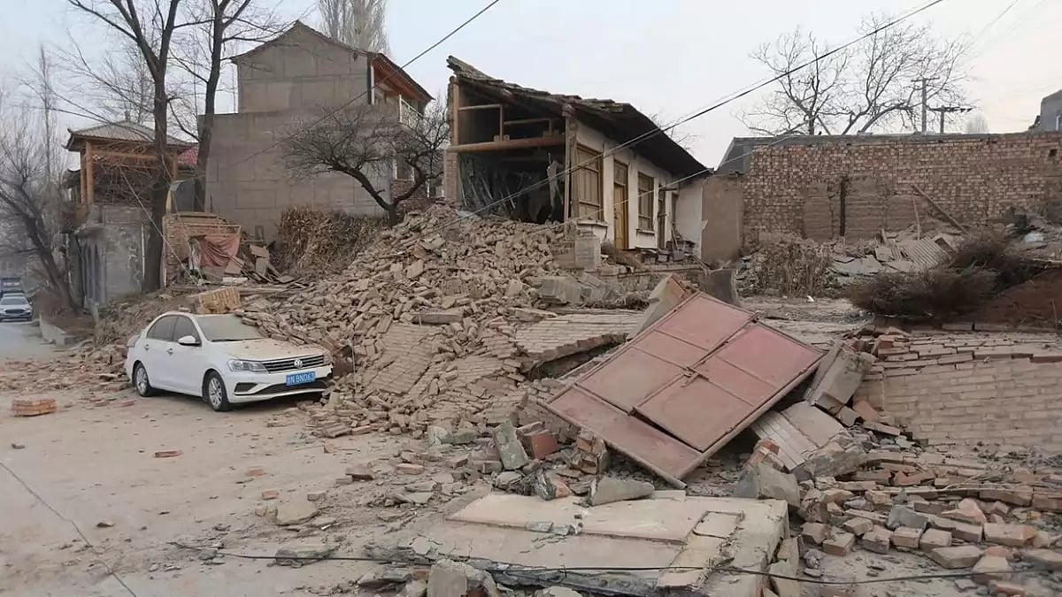 A vehicle is partially covered by a collapsed building in China's Gansu