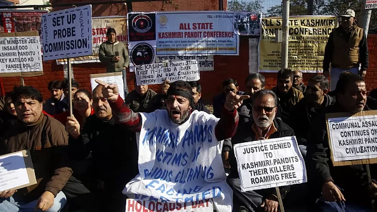 Kashmiri Hindu migrants shout slogans against Jammu and Kashmir government during a protest in 1990. - null