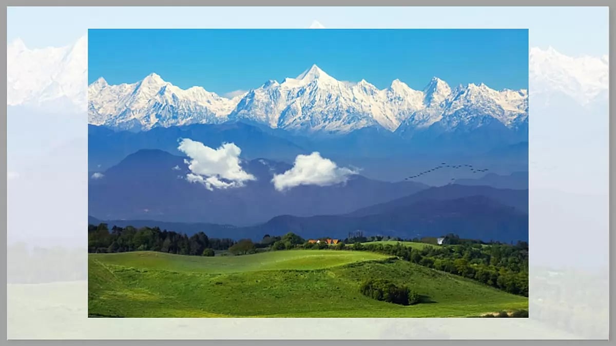 Scenic landscape with a view of the majestic Himalaya range and lush green meadows in Uttarakhand