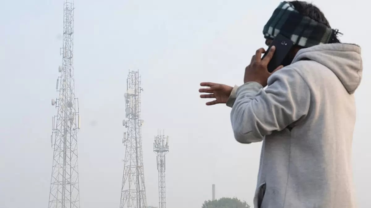 A man talks on his mobile phone near a telecom tower (representative image)