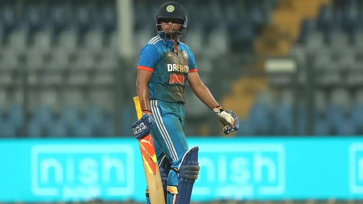 Richa Ghosh walks back to the pavillion after being dismissed for 96