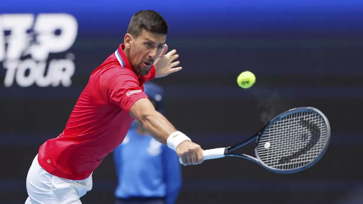 Novak Djokovic of Serbia hits a return to Jiri Lehecka of the Czech Republic during the United Cup t
