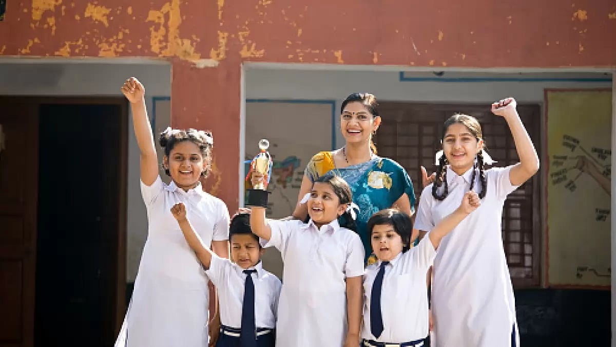 A school teacher with her students holding trophy and celebrating victory