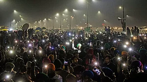 Protestors flash their mobile torches in the memory of 40 farmers who lost their lives during the 2020 protests in Ghaziabad.
