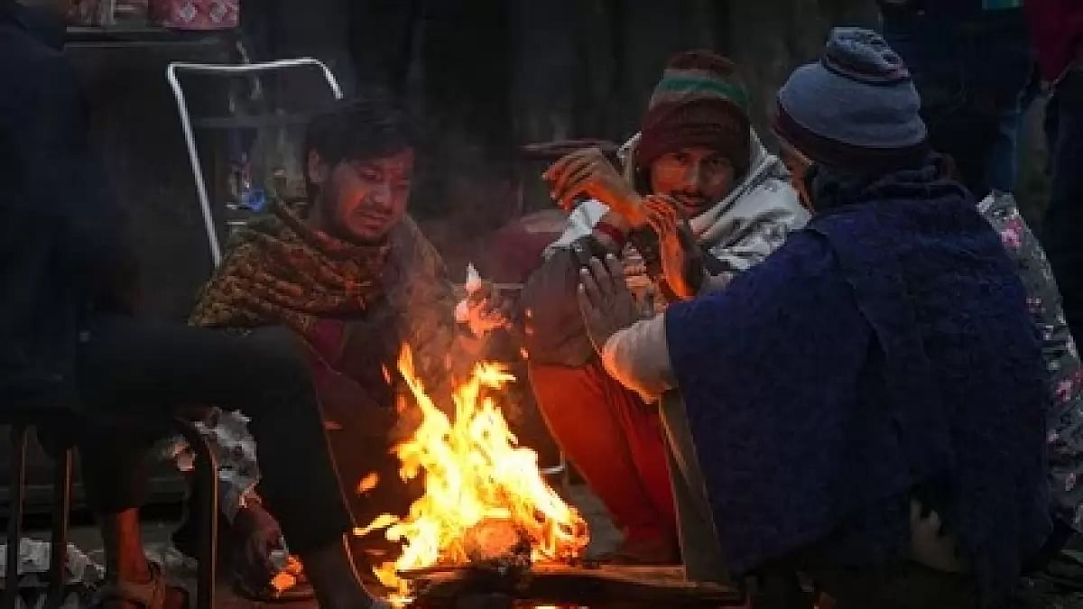People sitting around a bonfire amid biting cold in Delhi