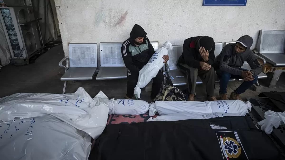 Palestinians mourn deaths of their relatives.