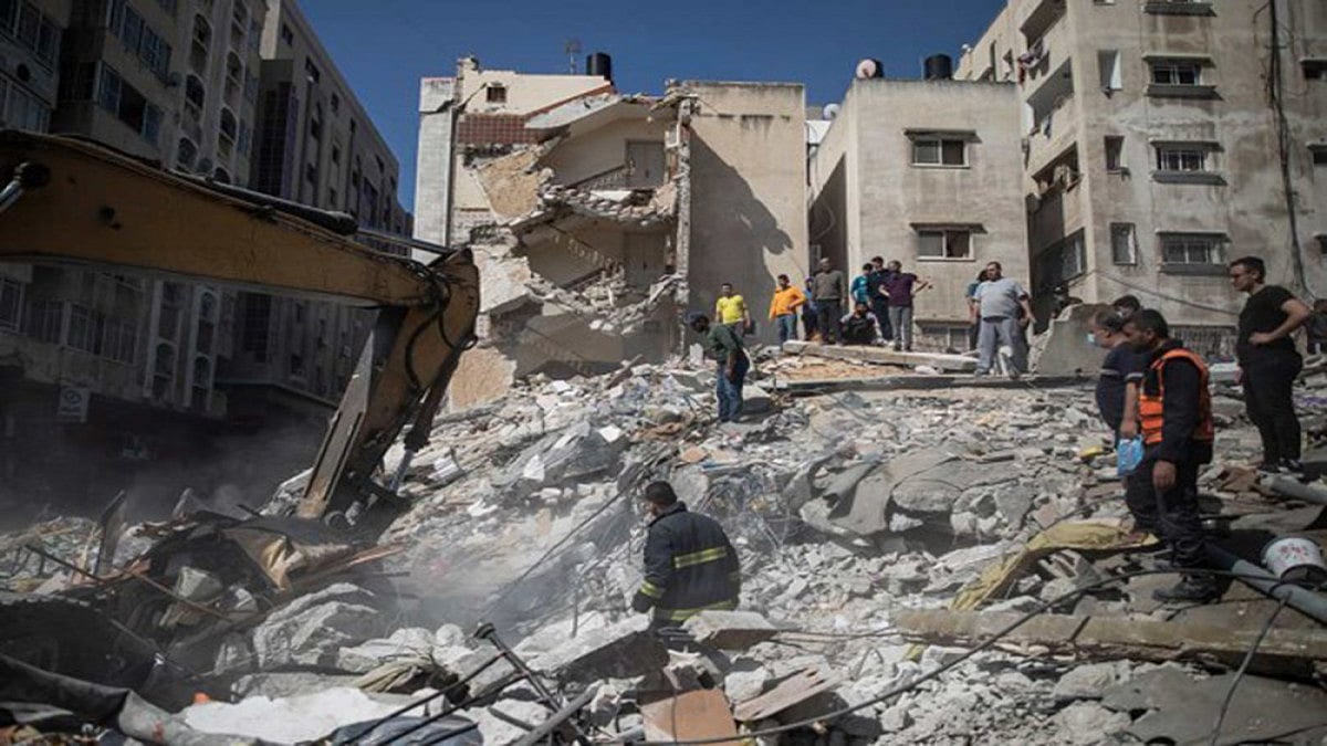 Palestinian rescuers search for survivors under the rubble of destroyed residential buildings following deadly Israeli airstrikes in Gaza City. 