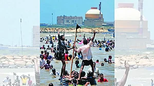 Activists and residents standing in the Bay of Bengal waters, protesting against the Kudankulam Atomic Power Project in 2012 (seen in the background)