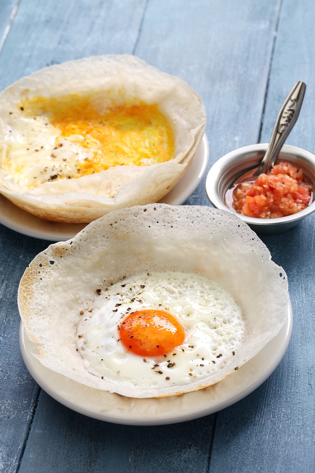 Egg Hoppers are served with chutney, coconut sambal, or chilli sauce