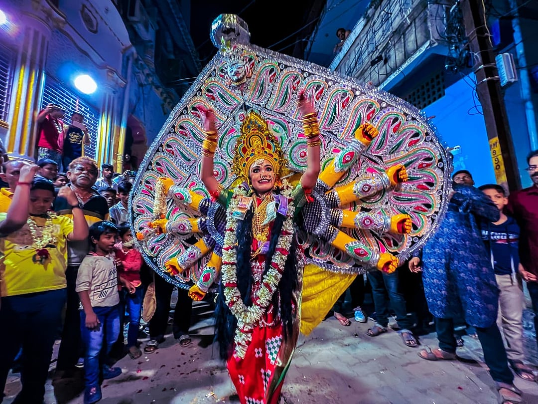 A child performer dressed as "Durga Medha" - Goddess Durga, dressed on "Tatti"- Shola Pith