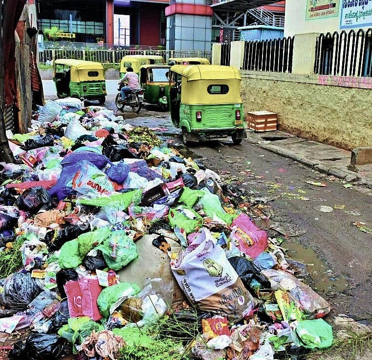 Garbage piles and waste dumped in Rajarajeshwari Nagar, making streets unusable for pedestrians