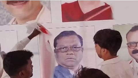 चूक लक्षात येताच व्यासपीठावर लावलेल्या  भाजप नेते कुलस्ते यांचा फोटो पटकन झाकताना  काँग्रेस कार्यकर्ते. 
