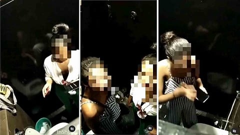 Two young women consuming drugs in the toilet