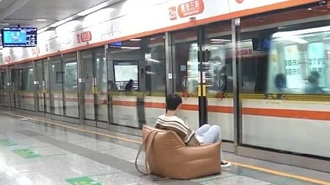 Man carries sofa 