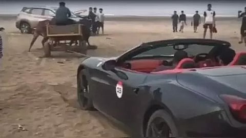 ferrari car stuck on a maharashtra beach was pulled out by a bullock cart 