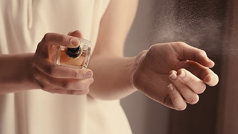 applying perfume 
