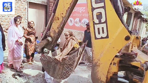 ulhasnagar woman jumps into jcb during demolition protest