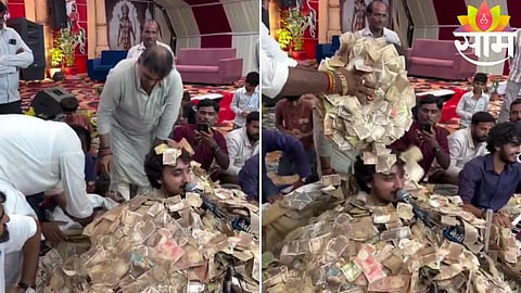 Devotees shower currency notes on a bhajan singer during a Dayro event in Gujarat’s Junagadh district.