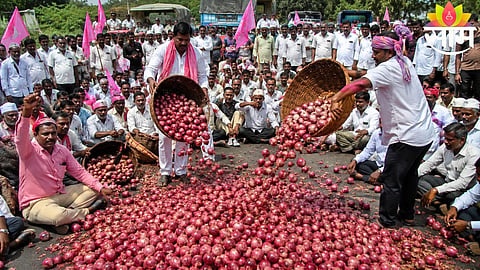 Angry onion farmers block highway and dump produce on road during protest over falling prices in Maharashtra.