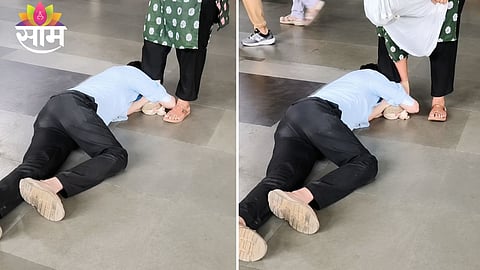 A screengrab from the viral video showing the youth kneeling before his girlfriend at Mumbai's Borivali railway station as commuters and security personnel look on.