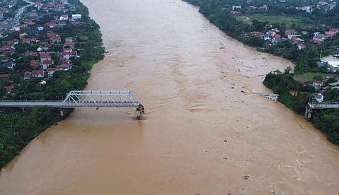 Flooding sweeps away bus and bridge collapses in Vietnam as storm deaths rise to 59 