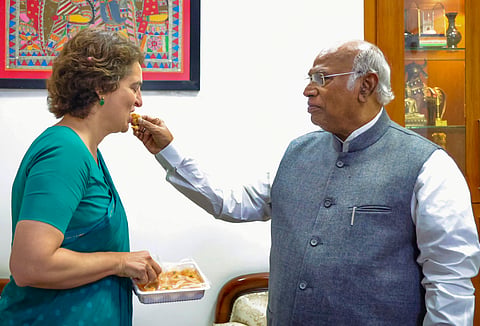 Priyanka Gandhi Vadra being offered sweets by party President Mallikarjun Kharge