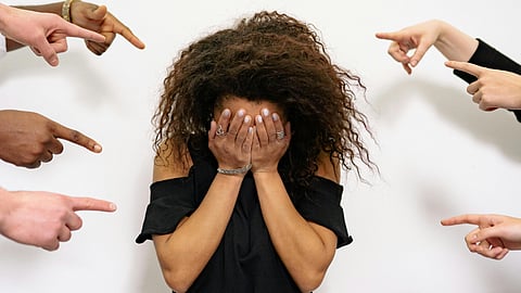 People Pointing Fingers at a Stressed Woman