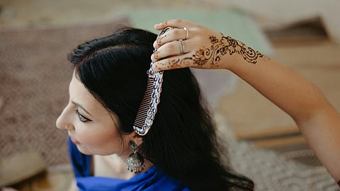Woman combing hair