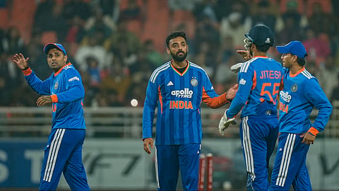 Varun Chakravarthy, second left, celebrates with teammates after taking the wicket of Reeza Hendricks