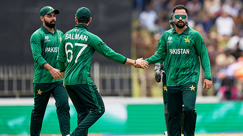 Pakistan's Mohammad Nawaz, right, celebrates with teammates the wicket of Netherlands' Bas de Leede