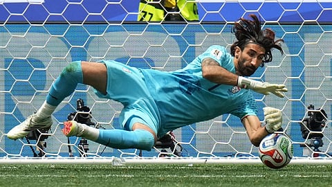 Iran goalkeeper Alireza Beiranvand makes a save during the World Cup Group G soccer match between Belgium and Iran 