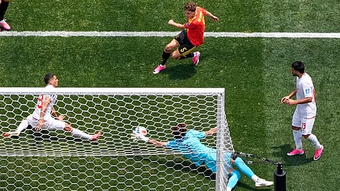 Iran goalkeeper Alireza Beiranvand (1) makes a save from Belgium's Maxim De Cuyper (5) during the World Cup Group G soccer match