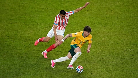 Australia's Jordan Bos (5) moves against Paraguay's Diego Gomez (8) during the World Cup Group D soccer match between Paraguay and Australia  