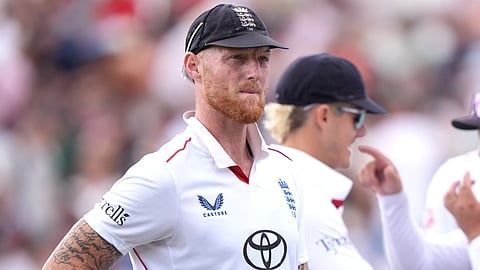England's Ben Stokes, left looks on with teammates on day four of the Third Test cricket match between England and New Zealand