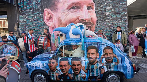 People gather to sing happy birthday to Lionel Messi at a street mural of him in Buenos Aires, Argentina,  