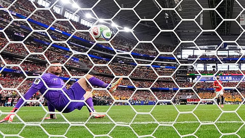 Egypt's Mohamed Salah (10) scores past Australia goalkeeper Mathew Ryan (1) during a penalty kick shootout in the World Cup round of 32 soccer match between Australia and Egypt