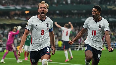 England's Harry Kane (9) celebrates with Jude Bellingham (10) after scoring his side's third goal through penalty kick during the World Cup round of 16 soccer match between Mexico and England