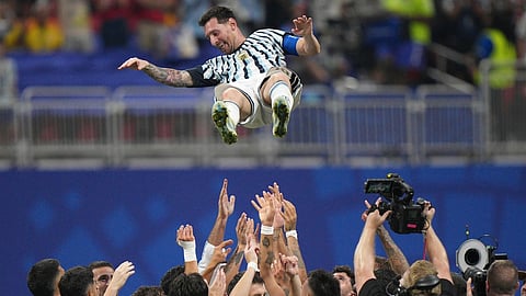 Argentina players toss teammate Lionel Messi (10) into the air as they celebrate after the World Cup round of 16 soccer match between Argentina and Egypt