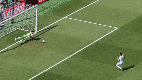 Morocco goalkeeper Yassine Bounou (1) stops a penalty kick against France's Kylian Mbappe (10) during the World Cup quarterfinal soccer match 