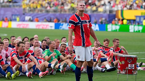Norway's Erling Haaland (9) leads the team as they participate in a viking boat row after the World Cup round of 16 soccer match between Brazil and Norway 